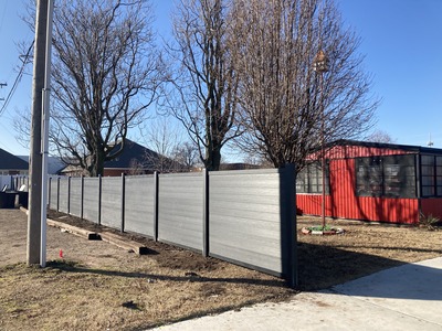 Grey Fence Red Building